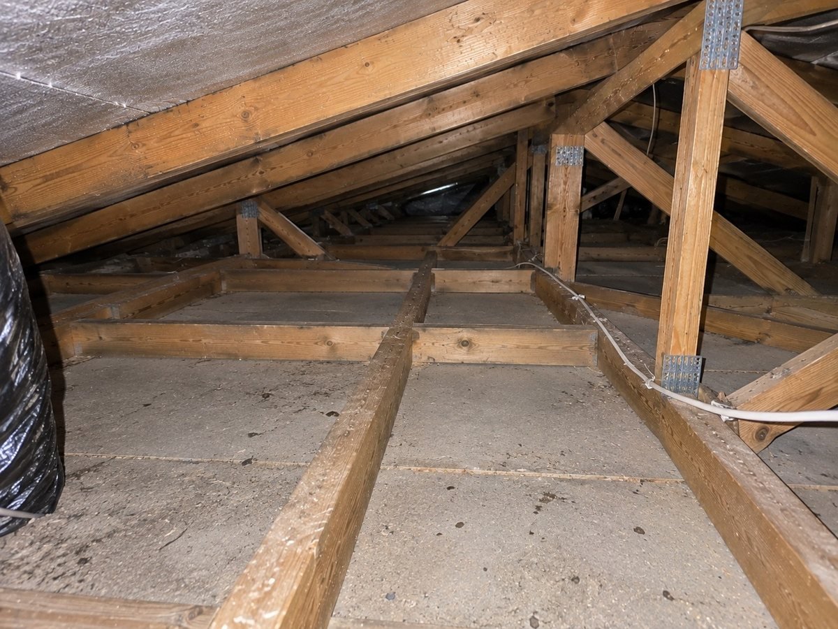 The same roof space cleared of insulation and vacuumed